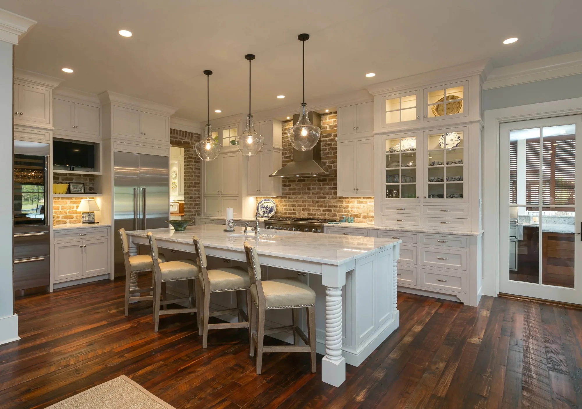 Coastal Comfort: white kitchen cabinetry with brick backsplash and reclaimed floors, Seabrook Island